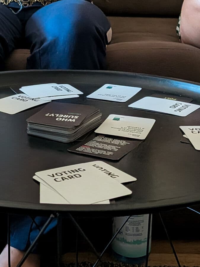 Who Surely? cards spread out on the table